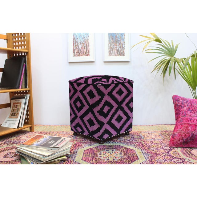 This chic, handmade ottoman is crafted from wood and upholstered with a hand-woven kilim wool rug. It serves as a multi-...