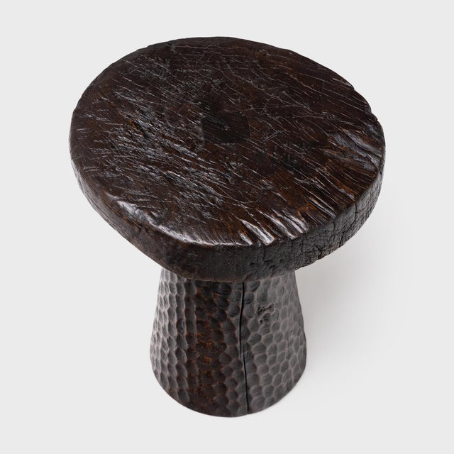 The round top of this pedestal side table is an antique wooden cart wheel, repurposed from an early 20th century wagon or...