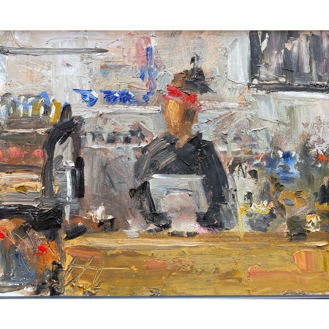 This oil painting captures a moment in a bustling café, where a figure sits at a table, seemingly engaged in conversation...