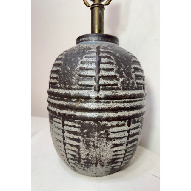 This antique handmade brutalist style terracotta electric table lamp is a unique piece of collectible lighting. It...