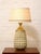 A striking vintage table lamp featuring a sculptural ceramic body covered in a deeply dimensional geometric relief. The...