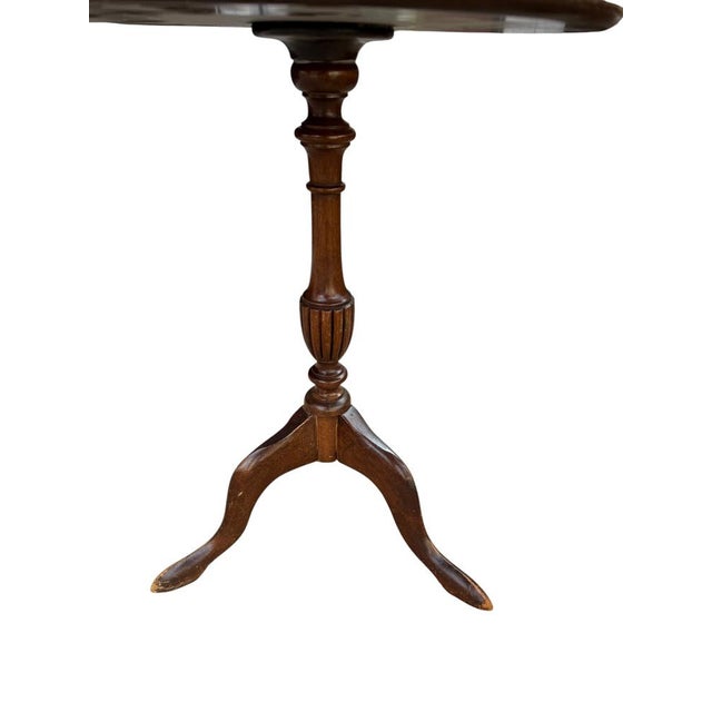 Antique-style tripod pedestal wine table featuring a circular top with a distinctive red leather inset. Features an...