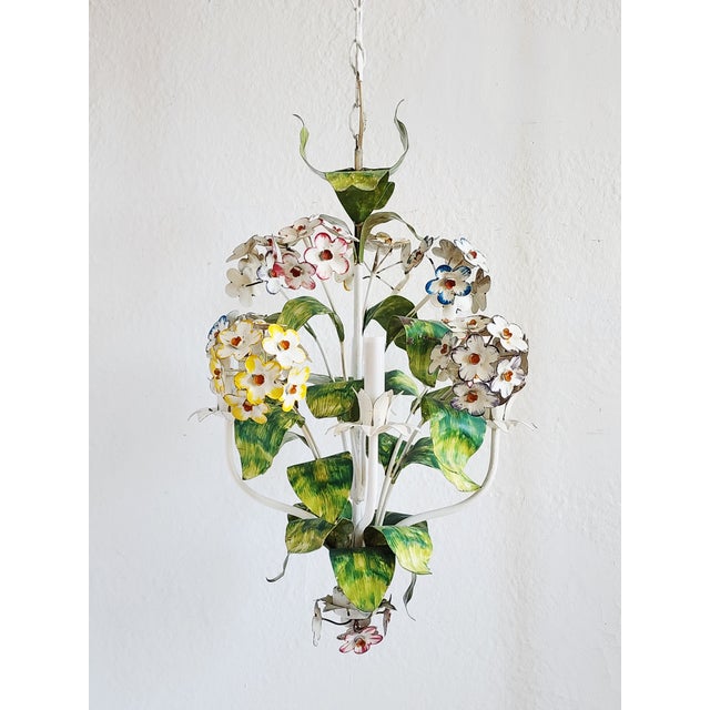 Mid-Century Italian tole painted floral motif chandelier with vibrant colors. The chandelier features clusters of flowers...