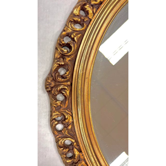 Vintage oval carved giltwood mirror. Can be hung horizontally or vertically.
