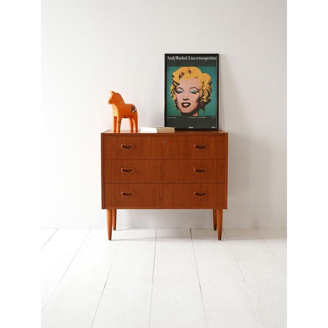 Vintage teak chest of drawers with three drawers and rounded carved handles, typical of Scandinavian design from the 60s....