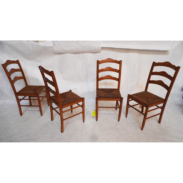 Set of Four Wooden Dining Chairs With Rush Seats These chairs have a simple design, with a ladder back and simple...