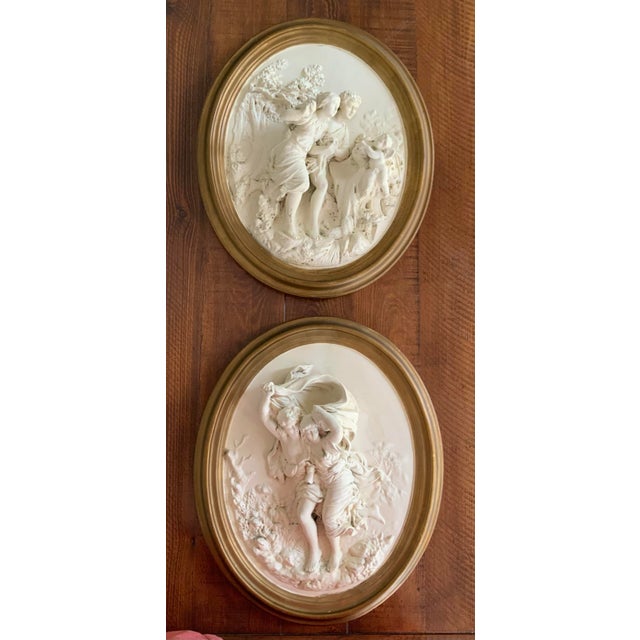 A striking pair of Statement Pieces. Vintage high-relief wall plaques depicting romantic classical figures in theatrical...