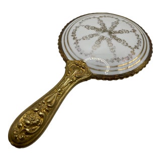 Antique Brass Repousse Beveled Hand Mirror With Porcelain Painted Back- 1920s For Sale