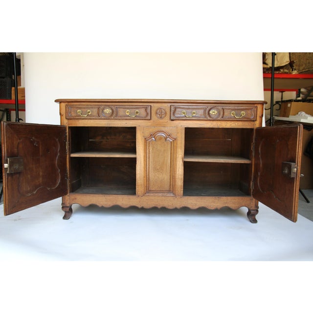 A beautiful antique French buffet featuring two drawers and two doors with brass drawer hardware and one key which unlocks...