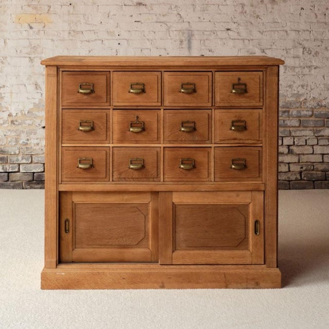 Add a rare and functional piece of history to your space with this late 19th century French Bank de France oak office...