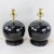 This exceptional pair of table lamps features a striking monochrome aesthetic, crafted from high-quality porcelain with a...