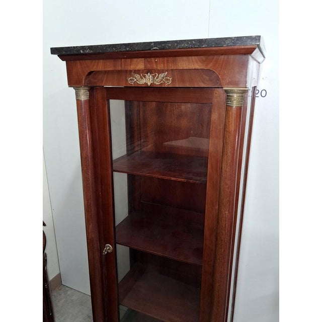 Empire Style Display Cabinet in Mahogany and Gilt Bronze with Black Marble Top, 19th Century, in Good conditions. Designed...