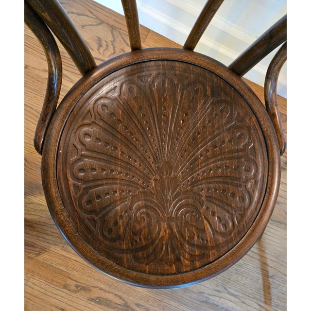 A beautiful pair of antique bentwood chairs showcasing the graceful curves and expressive detailing associated with the...