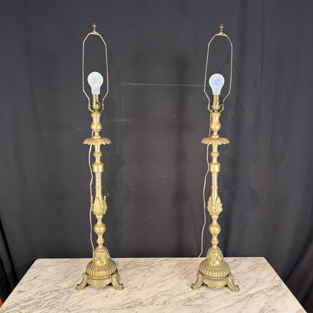 Elegant and intricate pair of antique French silver gilt metal church altar candlesticks, converted into tall table lamps....