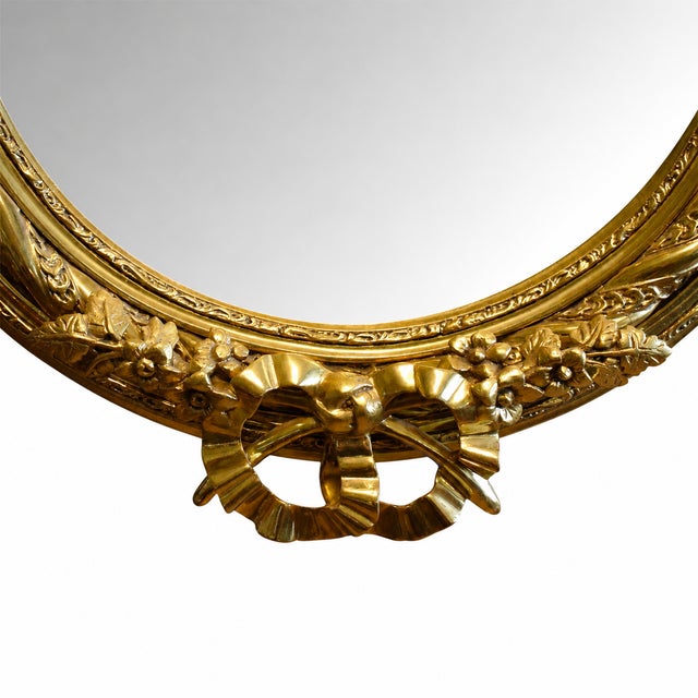 A large mirror in a striking, richly decorated gilded frame, reminiscent of Neo-Rococo styles. Its imposing proportions...