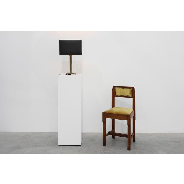 An elegant and architecturally refined table lamp designed and manufactured by Deknudt in Belgium during the 1970s....