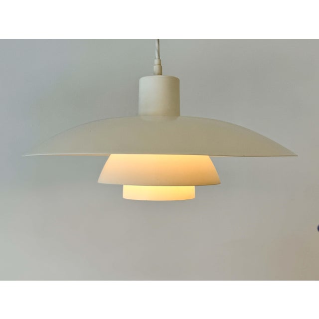 Iconic ph 4/3 pendant lamp designed by poul henningsen for louis poulsen in 1966. the lamp features henningsen’s...