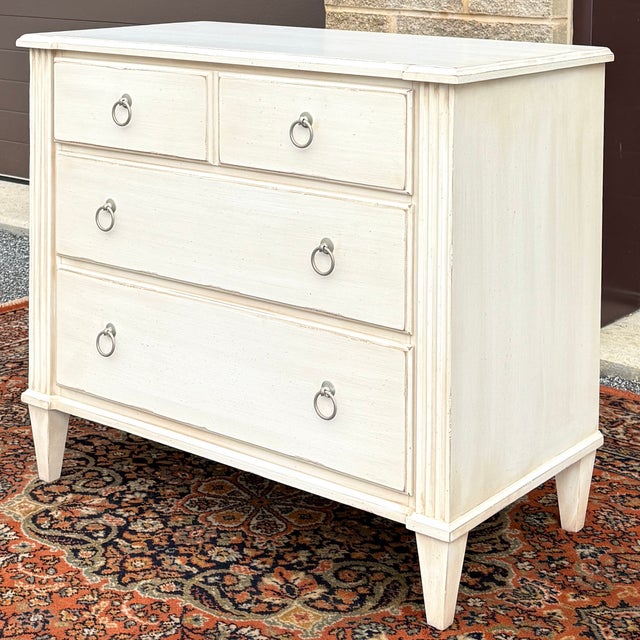 An early 21st century Ethan Allen Swedish Home collection Gustavian 3 drawer bachelor's chest in the #630 distressed beige...