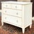 An early 21st century Ethan Allen Swedish Home collection Gustavian 3 drawer bachelor's chest in the #630 distressed beige...