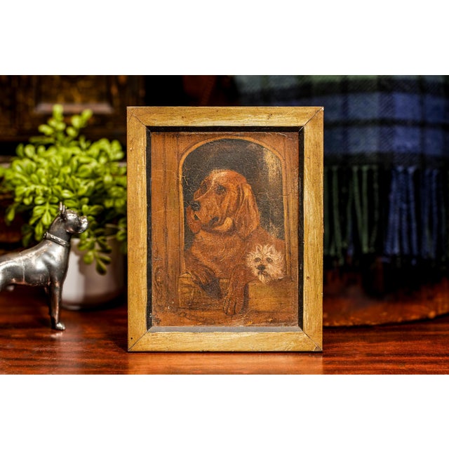 Capture the essence of a bygone era with this exquisite antique oil painting, a masterful depiction of two loyal canine...