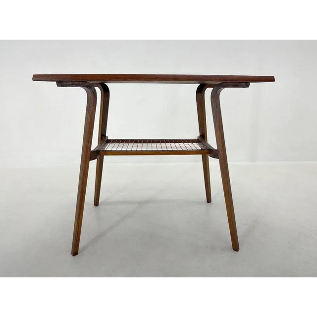 Vintage wooden coffee table that was commonly used as a TV table in the 1960s. Refinished. Wear consistent with age and use.