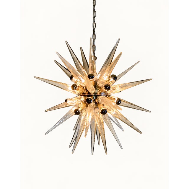 Italian Sputnik chandelier with 31 transparent Murano glass tips, hand-blown using traditional techniques. The tapered...