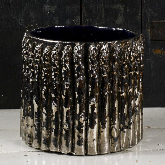 This original vintage vase stands out as a prime example of the eclectic design of 20th-century art ceramics, combining a...