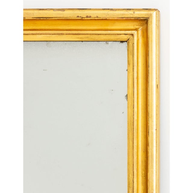 Rectangular Giltwood Framed Mirror. Mirror plate: 43.75" H x 21.5" W; frame: 49.5" H x 21.5" W x 1.5" D. Provenance: From...