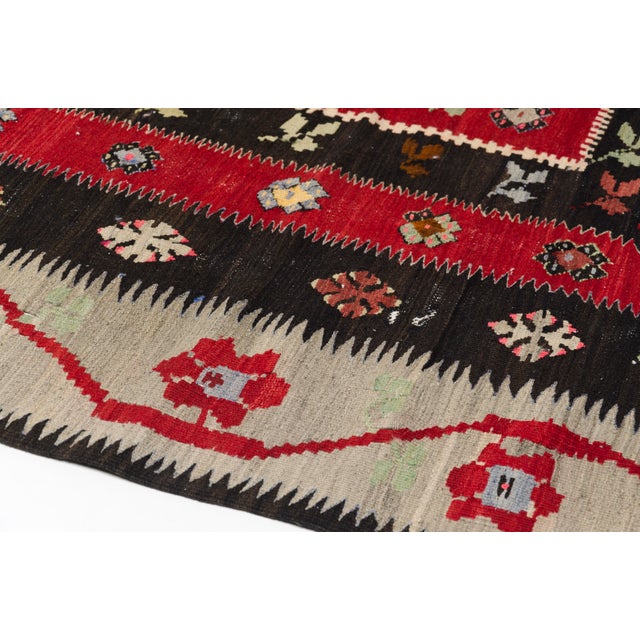 This is a vintage Turkish Oushak rug from the Mid 20th Century. The piece was hand-knotted.