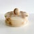 A round lidded box crafted from Italian marble in a classic tan and ivory checkerboard pattern. Smoothly finished with...