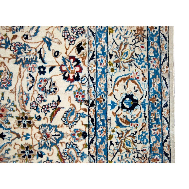 A wonderful late 20th century Persian Naein rug hand-woven in wool and silk with a beautiful densely woven scrolling vine...