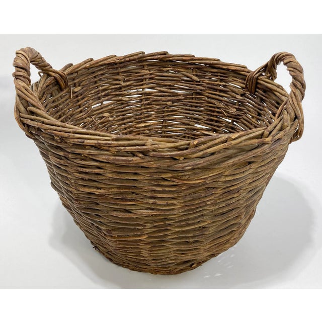 Large vintage wicker basket with prominent handles. Would make a great blanket or firewood basket, or even a nice planter....