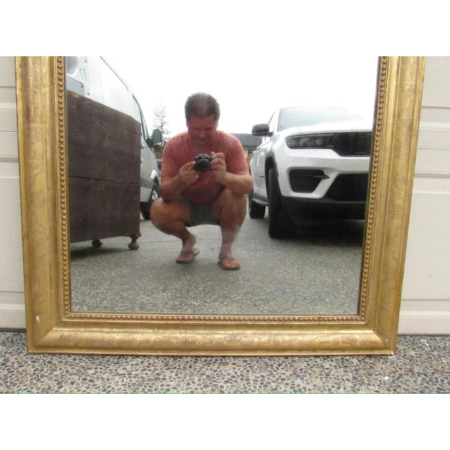 Antique French Louis Philippe giltwood mirror, c.1850 Having a molded frame with etched floral detail and decorative...