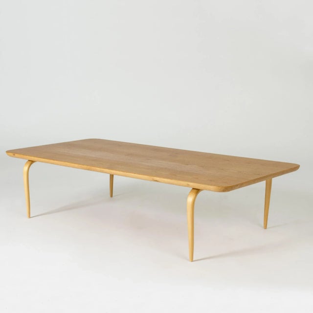 Coffee table by Bruno Mathsson, made from birch. Very low design, with elegantly rounded corners and curved legs. This...
