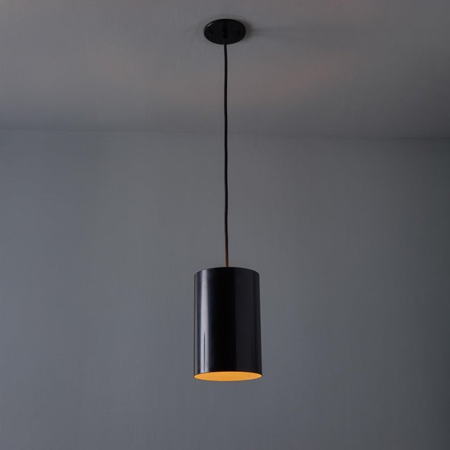 1960s Model 16513 Black Metal Cylindrical Pendants by Eila and John Meiling for Louis Poulsen Executed in black painted...