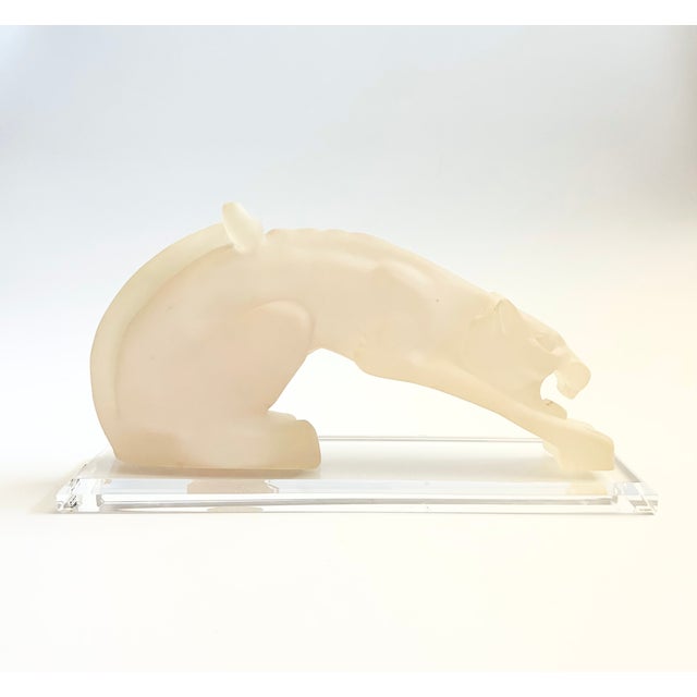 A vintage cast resin sculpture of a panther. Matte white finish, mounted to a clear lucite base. Wonderful stylized...