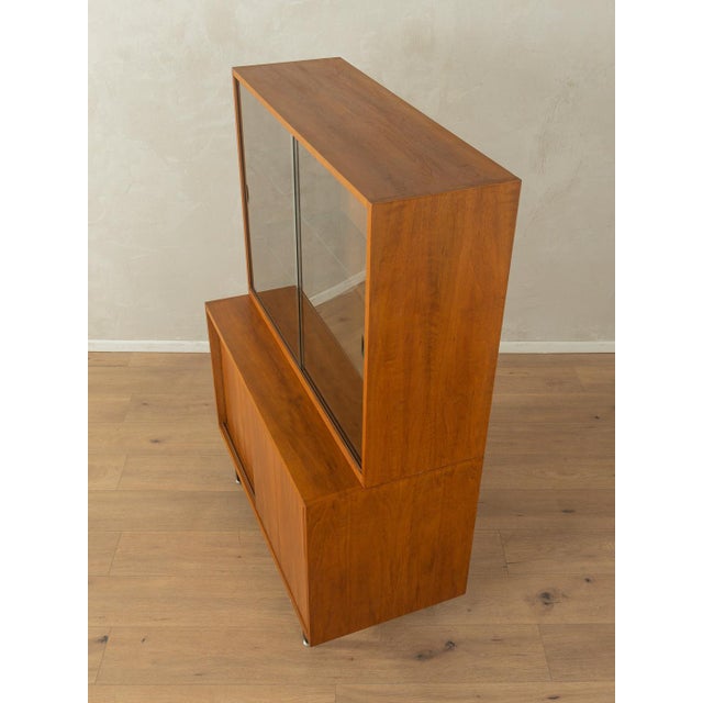 A wonderful two-part display cabinet from the 1950s. High-quality walnut veneer cabinet with two sliding doors, two glass...