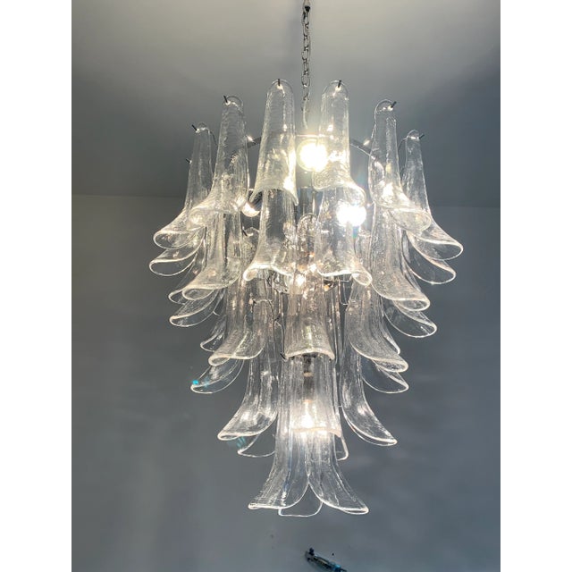 Contemporary Murano Glass "sella" chandelier with a chromed metal frame Selle in transparent Murano glass. For...