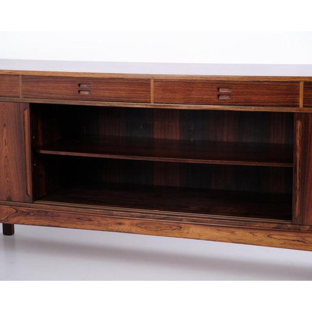 Rosewood sideboard designed by knud nielsen and manufactured by løsning møbelfabrik in the 1960s. The sideboard features...