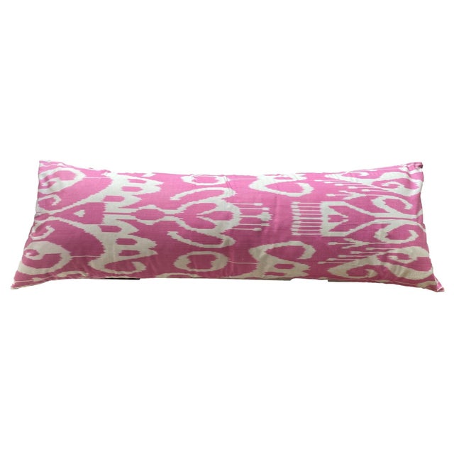 This pillow features a playful pink plaid design on the front that included shades of cream and subtle greens. The back...