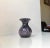 Small organically shaped vase. Made in turned black and purple spatter glass. Manufactured in Murano Italy during the...