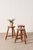 Antique French bobbin stool with a circular seat, turned bobbin legs, and an H-form stretcher, crafted from solid wood...
