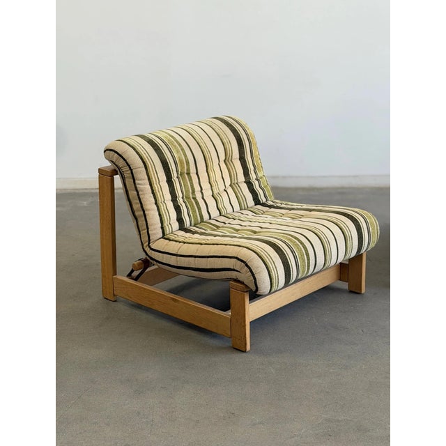 W29 D34 H26.5 SW29 SD21.5 SH14.75 A pair of vintage 1970s Swedish lounge chairs featuring warm oak-toned beech frames,...
