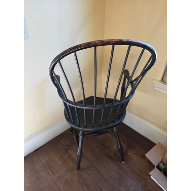 Beautiful primitive American Windsor hoopback chair with black painted finish and undertones of brown.