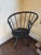 Beautiful primitive American Windsor hoopback chair with black painted finish and undertones of brown.