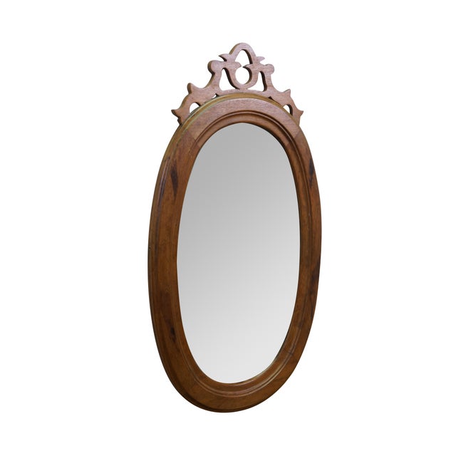Antique Victorian oval mahogany vanity or wall mirror features a carved, pierced (reticulated) wooden crest at the top....