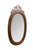 Antique Victorian oval mahogany vanity or wall mirror features a carved, pierced (reticulated) wooden crest at the top....