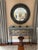 Very large striking round mirror having convex mirror surrounded by chunky grey wood or faux shagreen frame in classic...