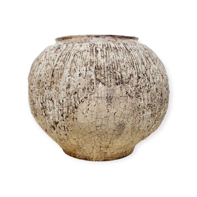 Industrial glazed ceramic vase from the 1970s. Its solid structure, raw color, and crackle glazed surface define a...