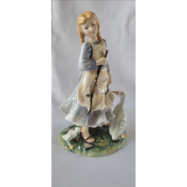 The Royal Doulton The Goose Girl HN2419 figurine ornament is a beautifully crafted porcelain piece from the renowned brand...